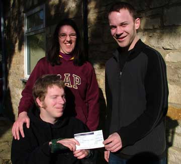 Tim Hills giving Will Fenton a cheque
